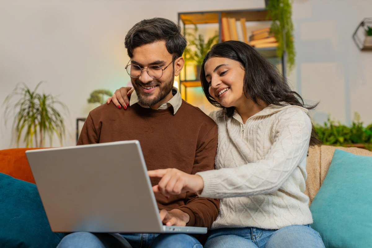 couple using a lap top to book an appointment